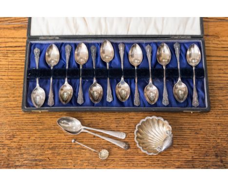 A cased set of twelve silver teaspoons, Birmingham 1942, weighing approx 2.82 ozt, with a shell shaped silver salt and spoon,