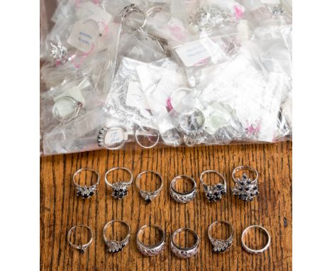 A collection of white metal rings and pendants stamped 925, the parcel comprises cluster, pave set, claw set, flush set rings