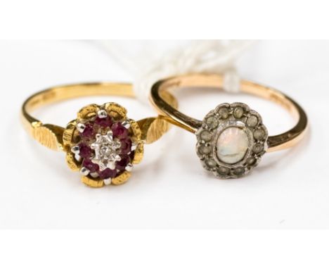 An 18ct (stamped) gold ruby and diamond cluster ring with bark effect shoulders size N1/2 and a 9ct gold opal and diamonds cl