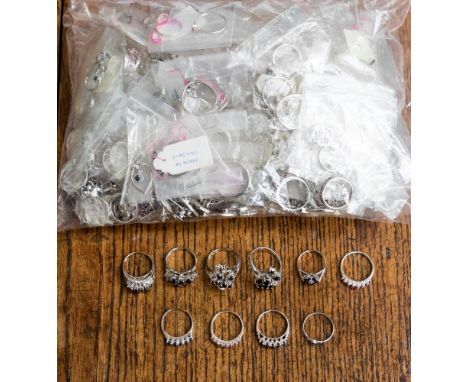 A collection of white metal rings and pendants stamped 925, the parcel comprises cluster, pave set, claw set, flush set rings