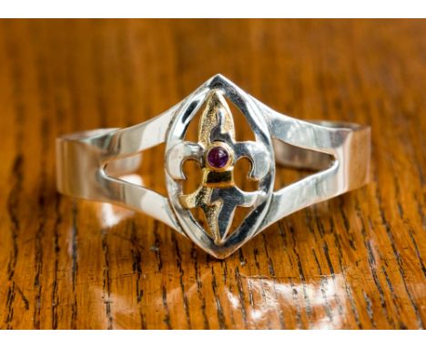 A silver amethyst and gold plate torque bangle fleur de lis motif design total gross weight approx 33.9gms. The central marqu