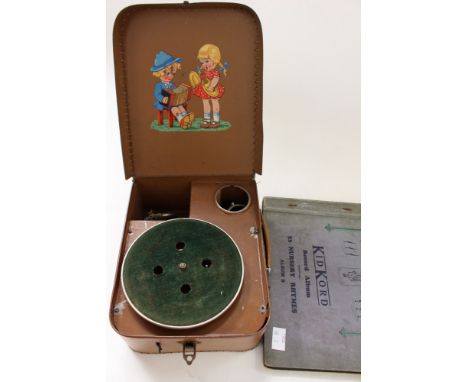 A child's mechanical record player, tin plate, with chrome and velvet, with needle and handle 1930s and "KidKord" record albu
