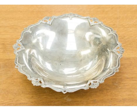 A late Victorian silver fotted rose bowl, Sheffield 1899, chased in the Rococo manner with scrolled foliate decoration, maker