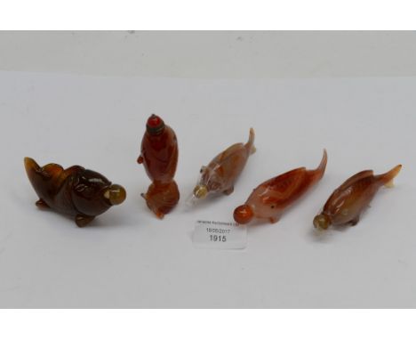 Chinese agate snuff bottles circa 1950, a group of five carved as carp, with detailed scales, the tallest 9.5 cm 