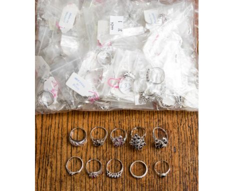 A collection of white metal rings and pendants stamped 925, the parcel comprises cluster, pave set, claw set, flush set rings