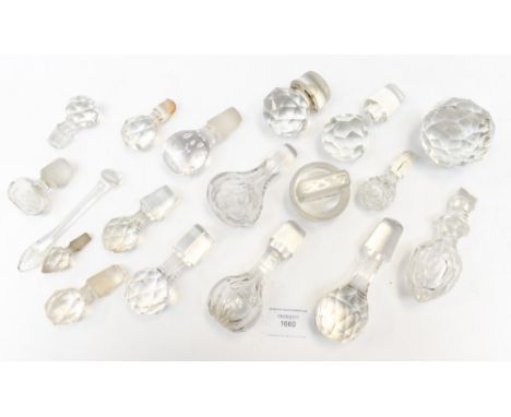 A box containing a collection of cut glass decanter stoppers