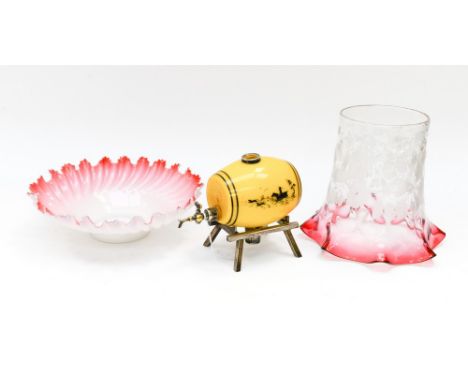 A glass lamp shade with wavy Cranberry edges fading into a raised flower pattern; together with yellow glass metal mounted wh