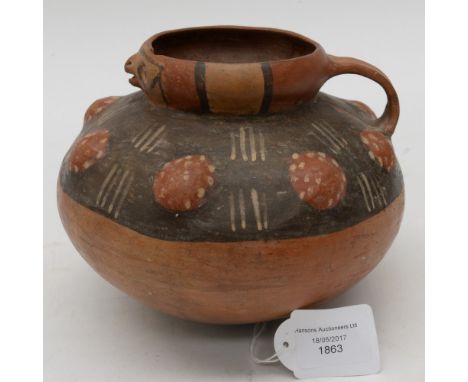 An ancient Inca terracotta vessel circa 100-200 AD, hand made and hand painted, loop handle and moulded bird face to the rim 