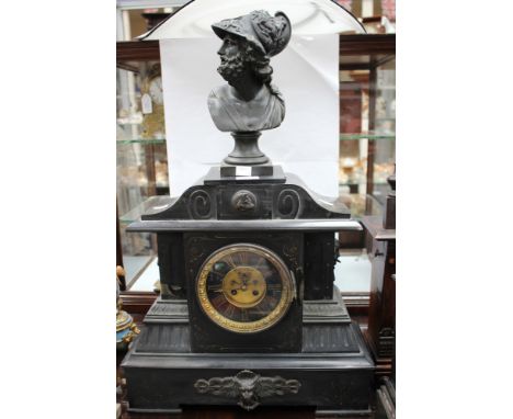 A large granite/slate mantle clock, with Greek God finial, Roman numerals 