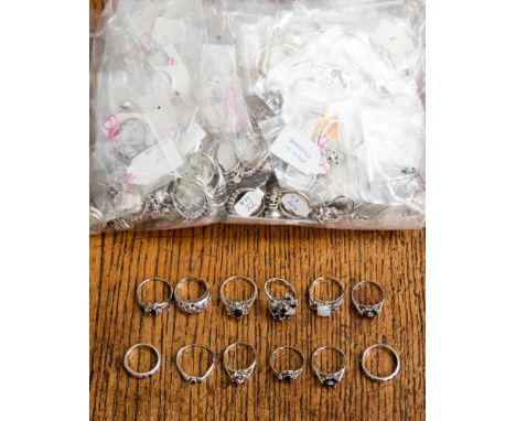 A collection of white metal rings and pendants stamped 925, the parcel comprises cluster, pave set, claw set, flush set rings