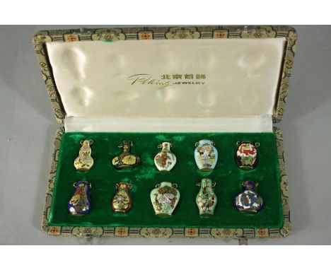 A Peking jewellery set consisting of a ten gold tone cloisonné pendants in the form of Chinese snuff bottles, each with a dif