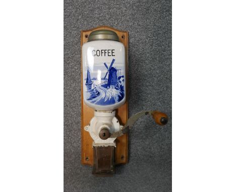 A vintage wall mounted coffee grinder, Dutch blue and white porcelain and with maker's mark. H.44 W.14cm 