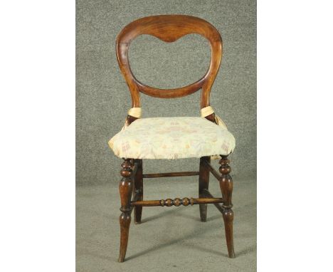 A Victorian walnut saddle back dining chair, on turned splayed legs, joined by bobbin turned stretchers. 