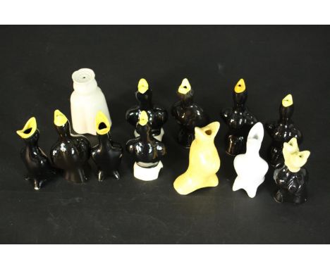 A collection of twelve vintage ceramic pie funnels, including eleven in the form of singing black birds, one with two heads. 