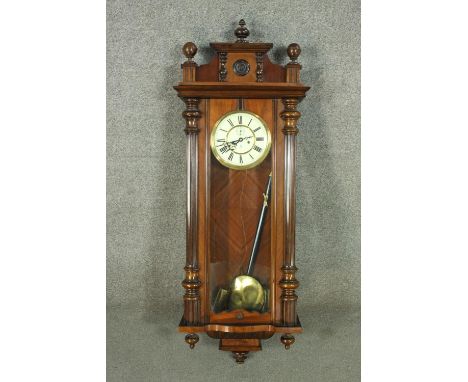 A late 19th century Gustav Becker walnut cased Vienna regulator with Roman numerals on a white enamel dial.  H.125cm W.46 D.1