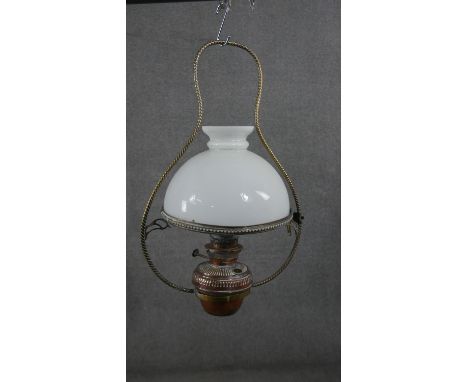 A 19th century hanging oil lamp with milk glass shade and a similar example with copper reservoir. H.60 W.46cm H.63 W.40cm 