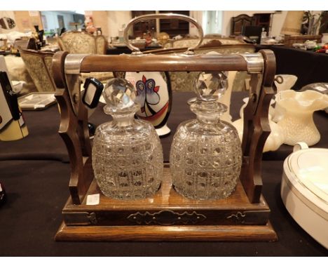 Mahogany tantalus with key containing two hobnail cut oval shaped decanters CONDITION REPORT: This item has no markings/names