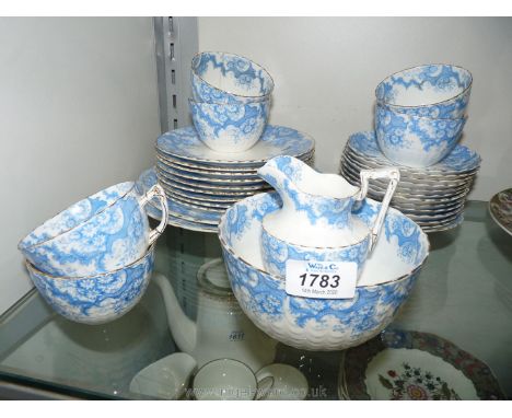 A china Teaset, white with a blue flower border and gold fluted edge, six cups, twelve saucers, nine side plates, jug, sugar 