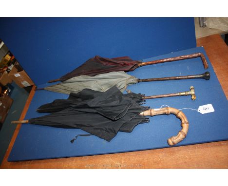 Three Victorian silk umbrellas one having mother of pearl handle and a gents umbrella with bamboo handle.