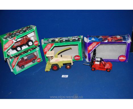 Four boxed Siku vehicles, including a 2561 Land rover Defender Pick-up, a Claas Teleskoplader Ranger 911T and 2861 Fiat-Tract