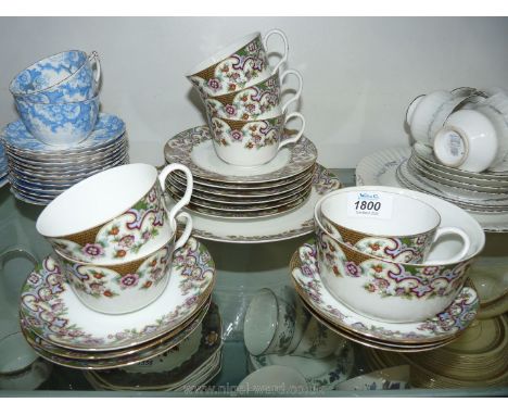 A twenty piece part tea set, white with flower border in pinks, green and gold including cake plate, side plates, six cups an