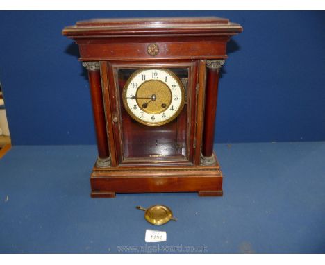 A German table Clock, having two train with pillar decoration to the side.