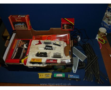 A quantity of Hornby railway OO gauge including track, water tower, engine shed, main line station, advertising carriages to 