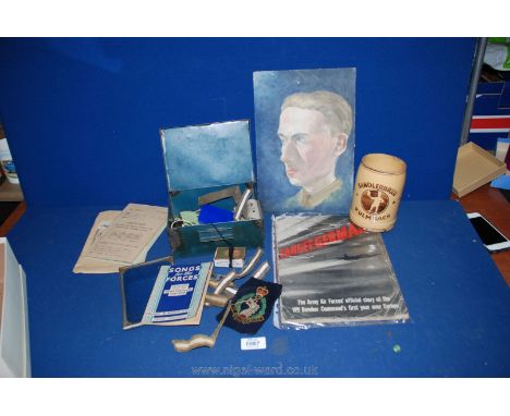 A box of miscellaneous military items including uniform badges ''Target:Germany'' book, portrait of a soldier, German tankard