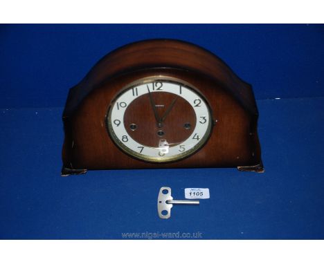 A wooden mantle clock with key having Westminster chimes.
