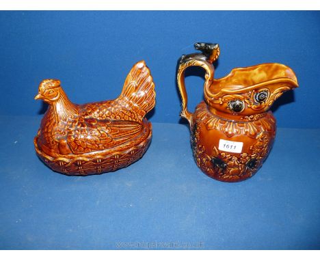 A brown Portmeirion hen on nest and an Arthur Wood brown hunting jug having a horses head on the handle.