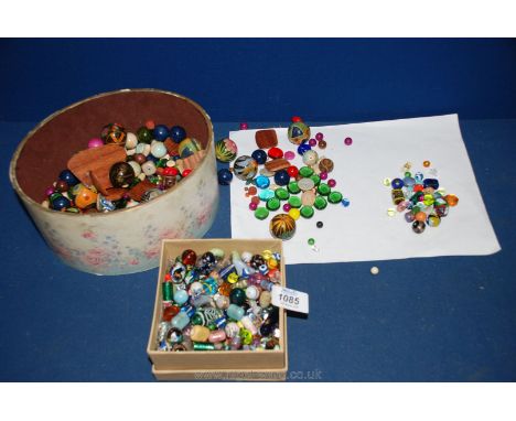 A box of old Venetian style glass and ceramic Beads and an oval box of a wooden painted beads, glass beads, etc.