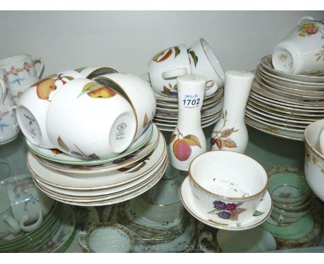 A part Royal Worcester 'Evesham' Teaset including eight plates, six cups and five saucers, salt &amp; pepper pots, small souf