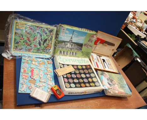 A box of vintage puzzles, relief paperweights, Play &amp; Learn, kids tool set in box etc.