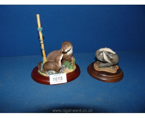 A Border Fine Arts 'Mammals' by Studio of an otter and kit (no: A20443), plus a figurine of two badgers playing.