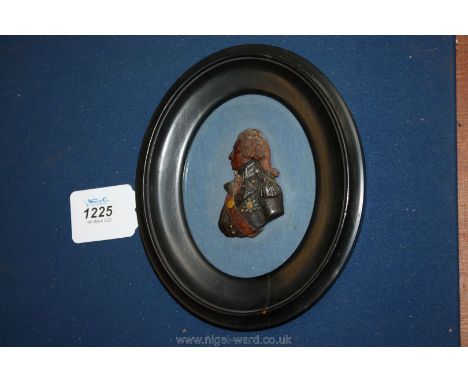 An early 19th c. carved and painted wax profile portrait of Admiral Lord Nelson, facing left in naval dress, framed.