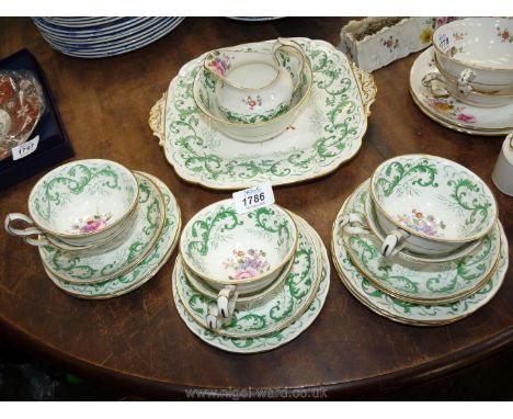 A Royal Crown Derby tea set including cake plate, six side plates, six cups and saucers, jug and sugar bowl, white with green