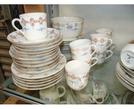A pretty china Teaset, white with pink and gold decoration with blue leaf consisting of eight cups, ten saucers, ten side pla