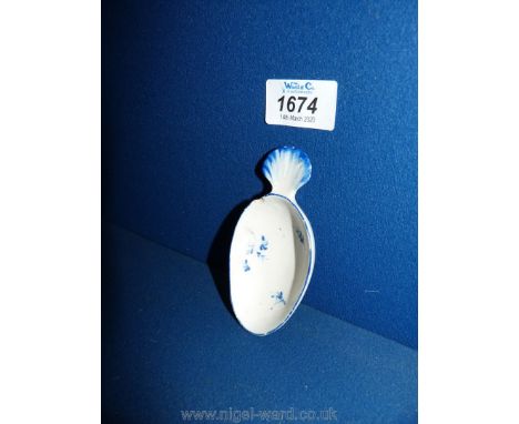 An 18th c. very scarce English porcelain caddy spoon painted in blue with shell handle and floral decoration to the bowl, pro