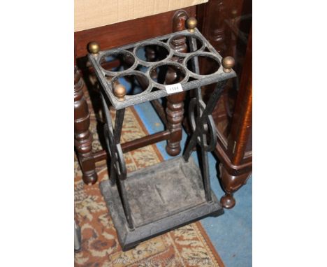 An unusual cast iron stick/umbrella Stand with drip tray (cracked) to the base, six recesses and four knob finials, 11'' x 14