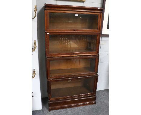 An Oak Globe Wernicke Four Tier Stacking Bookcase, three tiers labelled Globe Wernicke, one tier stamped Gunn sectional bookc