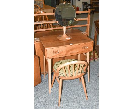 A Ercol Light Elm Dressing table, with single drawer, on splay supports with turned stretchers. 69cm by 49cm by 74cm, togethe