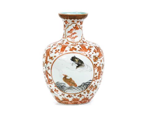 A Chinese Porcelain Vase, Qianlong mark but 19th century, painted in iron red, black enamel and gilt with two roundels contai