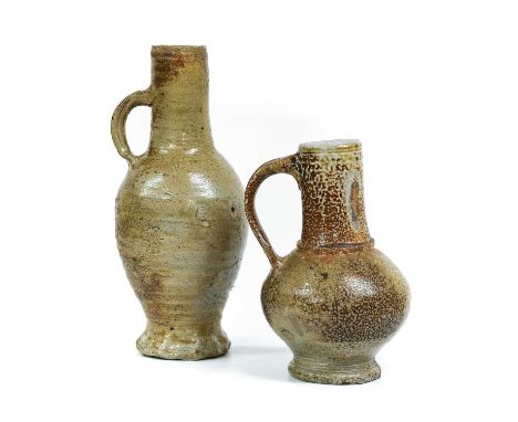 A Sieburg Stoneware Jug, 15th century, with tall cylindrical neck, grooved loop handle and ribbed ovoid body over a gadrooned