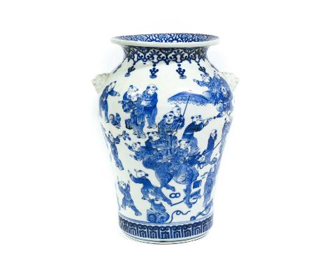 A Japanese Porcelain Vase, late Meiji period, with moulded komainu mask handles and painted in underglaze blue with a continu