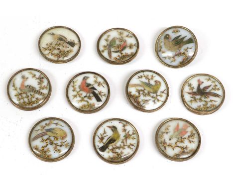 A Set of Ten Appliqué Buttons, 1st half 19th century, worked with feathers and seeds, depicting birds perched in branches, un