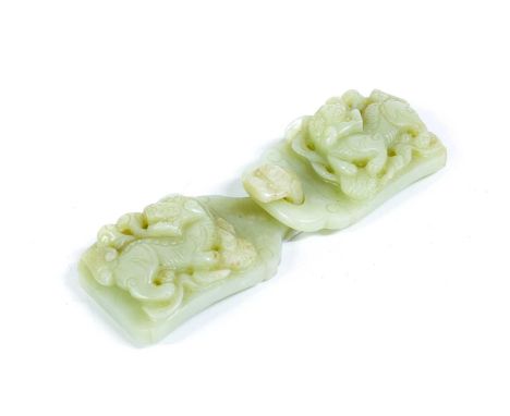A Chinese Jade Belt Buckle, in two parts, each half carved in relief with dogs of Fo12.5cm wide overallThe hook sided section