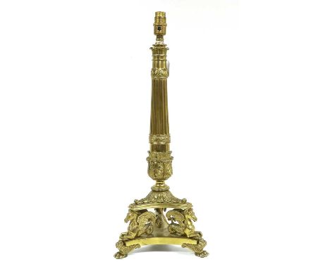 A Gilt Metal Lamp Base, in Empire style, the acanthus leaf-sheathed fluted column on a tricorn base with hippocampae on leaf-
