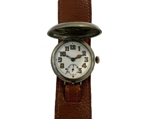 Unsigned - A base metal 'trench' style 'wristlet' hunter wristwatch,  circa 1914, the unsigned white dial, 28mm diameter, wit