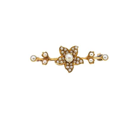 An Edwardian split pearl brooch, a central flower, mounted to a knife edge bar, with trefoil terminals, pin and roller catch 