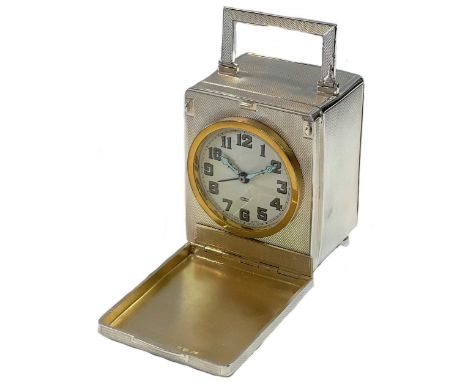 Unsigned - A Sterling silver travelling clock with unusual front cover and rear compartment, circa 1929, the unsigned parchme